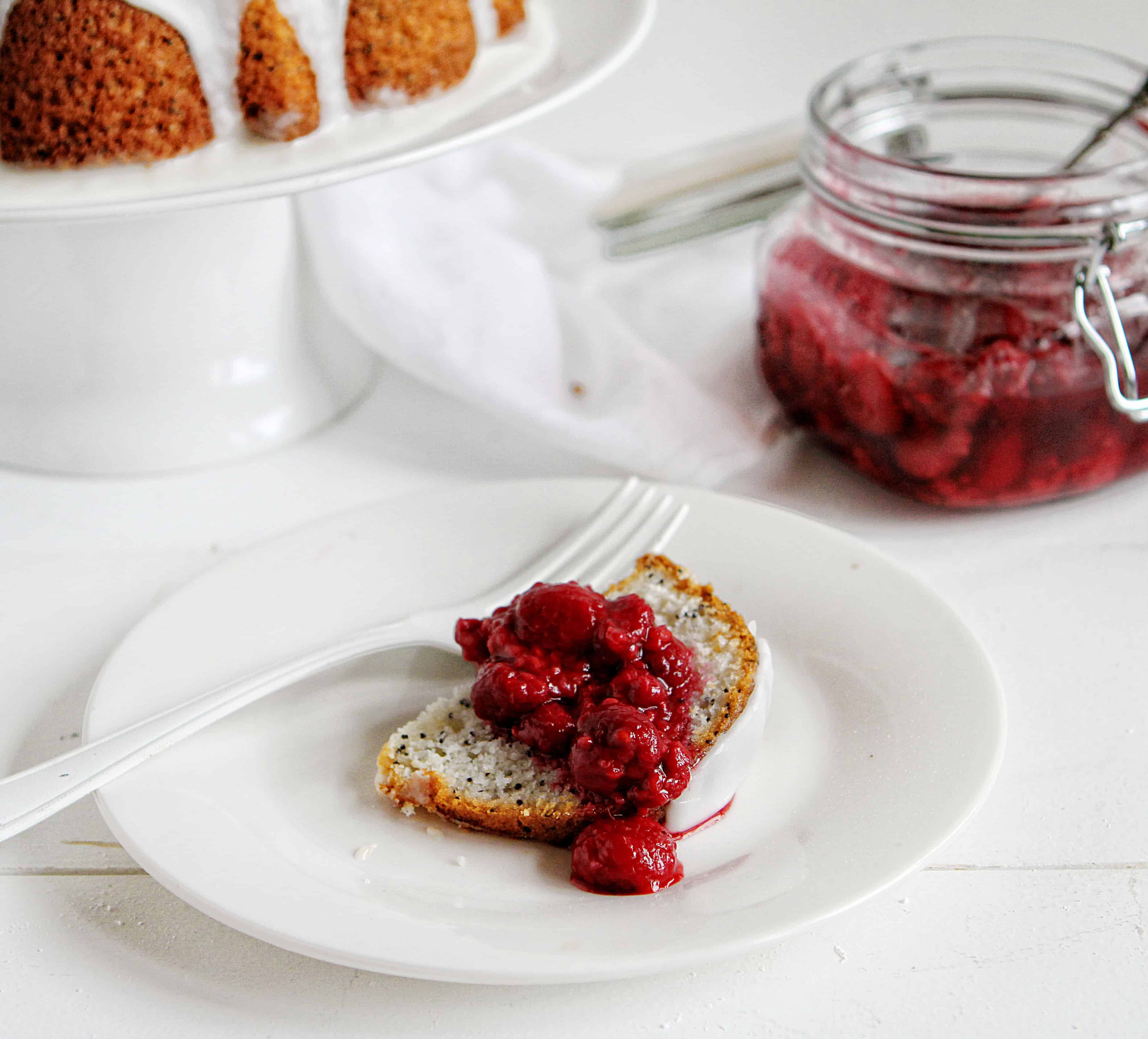 This Vanilla Poppyseed Cake with Raspberry Topping is a delicious and beautiful treat! #poppyseedcake #bundtcake #baking #recipes #cake #raspberrytopping #vanillaglaze #iambaker 罂粟籽香草蛋糕