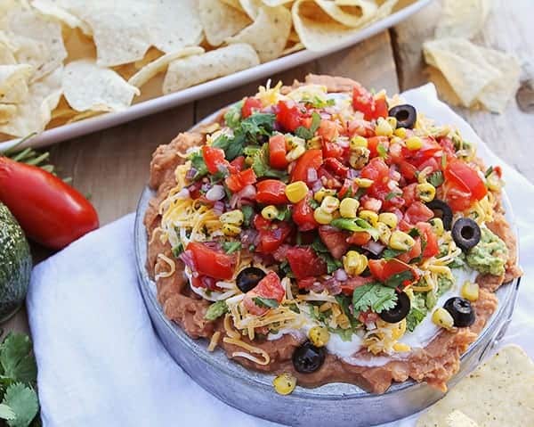 Your party just went next level! Adding roasted corn to traditional 7-layer dip is absolutely delicious! #iambaker #appetizer #gameday #superbowlfood #sevenlayerdip 培育浸gydF4y2Ba