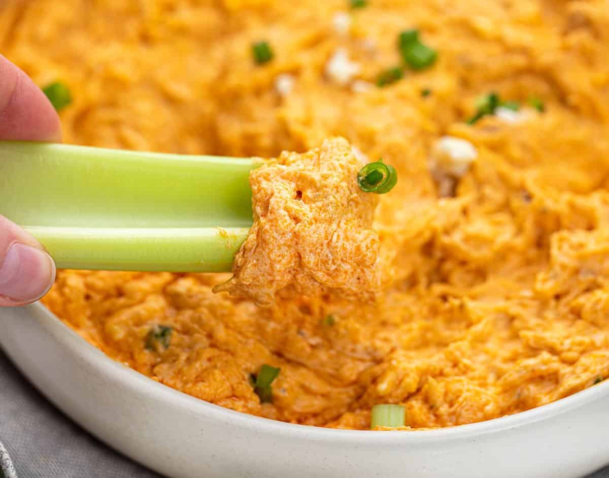 Crockpot Buffalo Chicken Dip is an appetizer made with chicken, cream cheese, cheddar cheese, sour cream, and homemade buffalo sauce. Appetizer, Buffalo Chicken Dip, Slow Cooker Buffalo Chicken, Crockpot Buffalo Chicken, Dips, Superbowl Recipes, Game Day Recipes, Hot Appetizers, Buffalo Chicken Recipes, i am baker, iambaker 芹菜勺水牛城鸡肉蘸酱