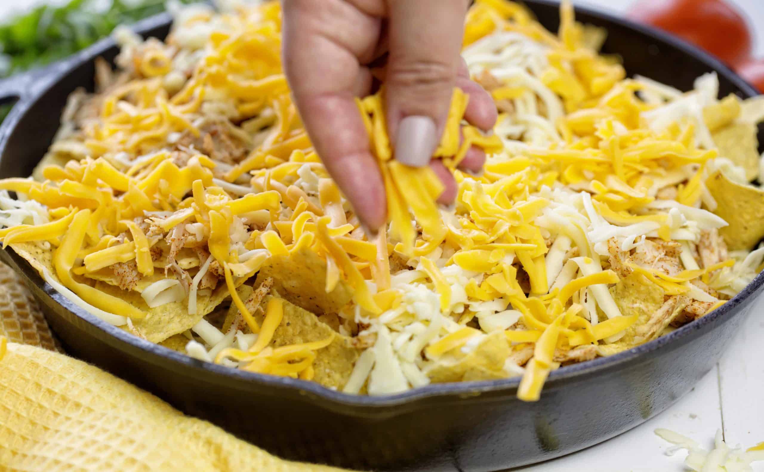 Skillet Chicken Nachos are the BEST way to enjoy nachos at home! Better than any restaurant! #nachos #chickennachos #howtomakenachos #skilletnoachos #easychickennachos #iambaker Cheesy Chicken Nachos