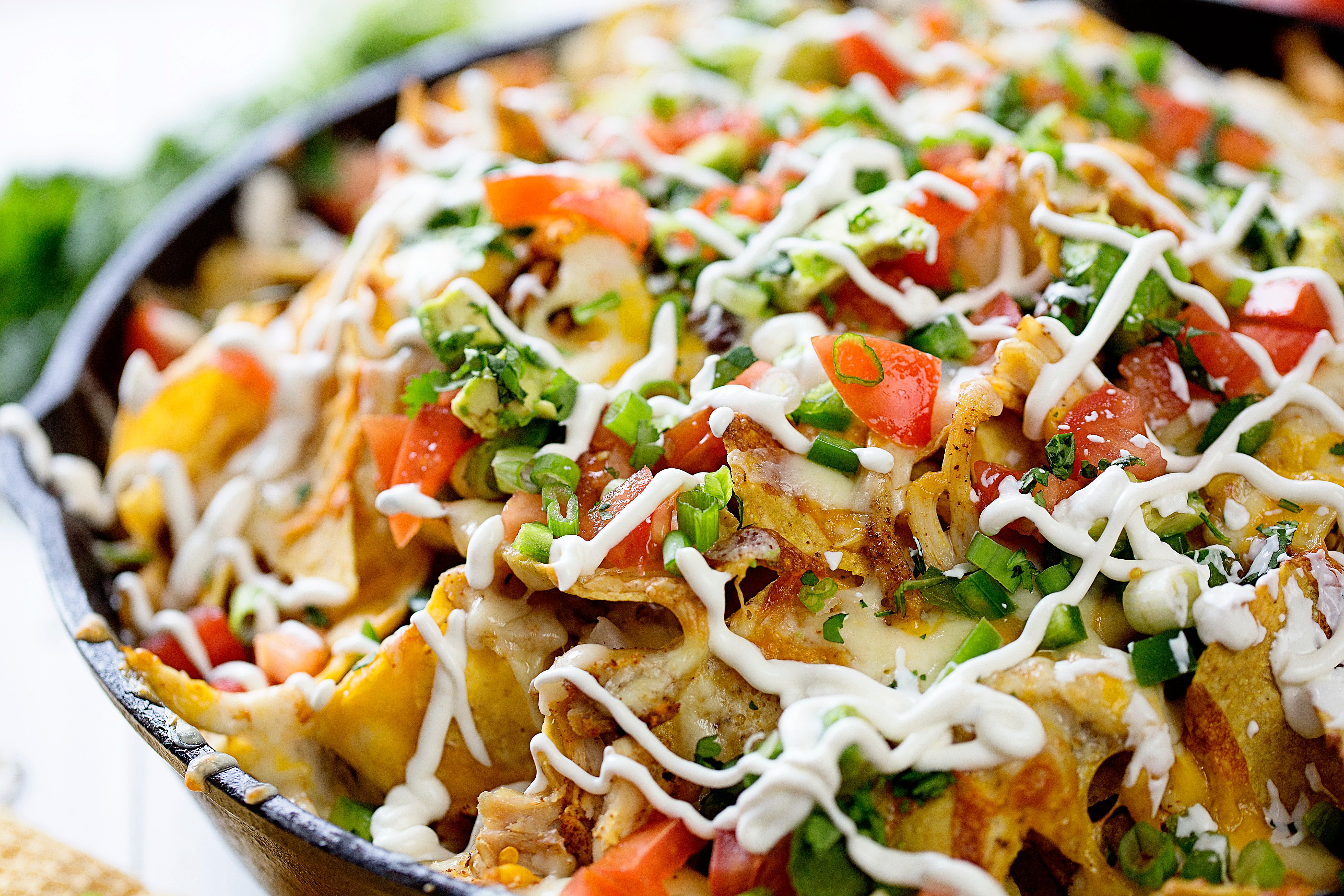 Skillet Chicken Nachos are the BEST way to enjoy nachos at home! Better than any restaurant! #nachos #chickennachos #howtomakenachos #skilletnoachos #easychickennachos #iambaker Skillet Chicken Nachos