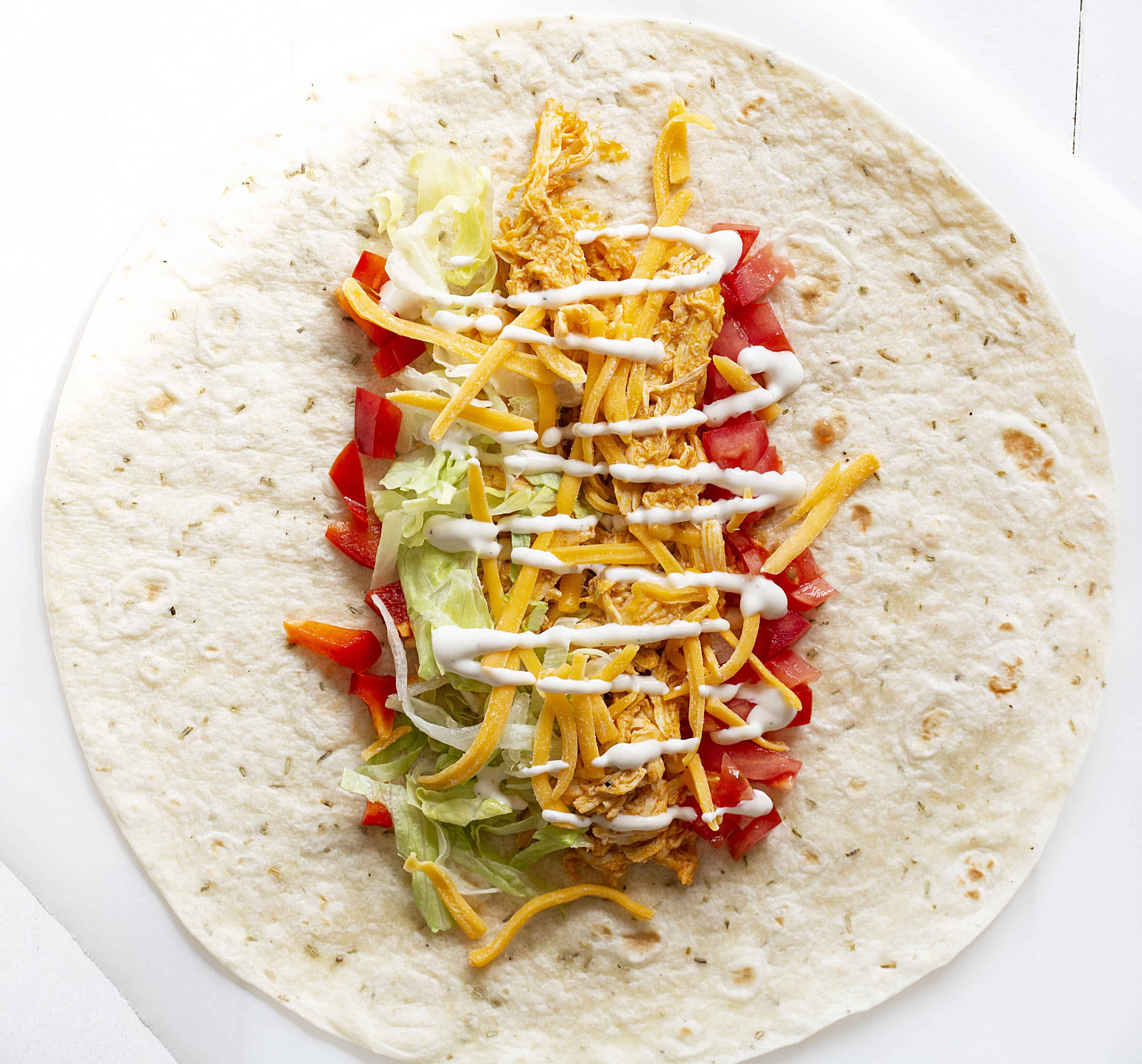 Buffalo Chicken Wraps are a quick and easy lunch or dinner meal! buffalo sauce, buffalo chicken, buffalo chicken wraps, wrap recipes, chicken wraps, rotisserie chicken, chicken recipes, iambaker 布法罗鸡肉食谱