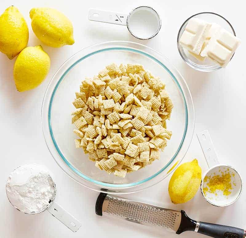 Lemon Puppy Chow (aka Muddie Buddies) is a super fun citrus twist on a classic! Sweet vanilla and lemon flavor all wrapped up in an easy-to-eat snack! #lemonpuppychow #lemonmuddiebuddies #puppychow #puppychowrecipe #muddiebuddies #easysnacks #snacks #afterschool #iambaker #nobake 柠檬小狗食材