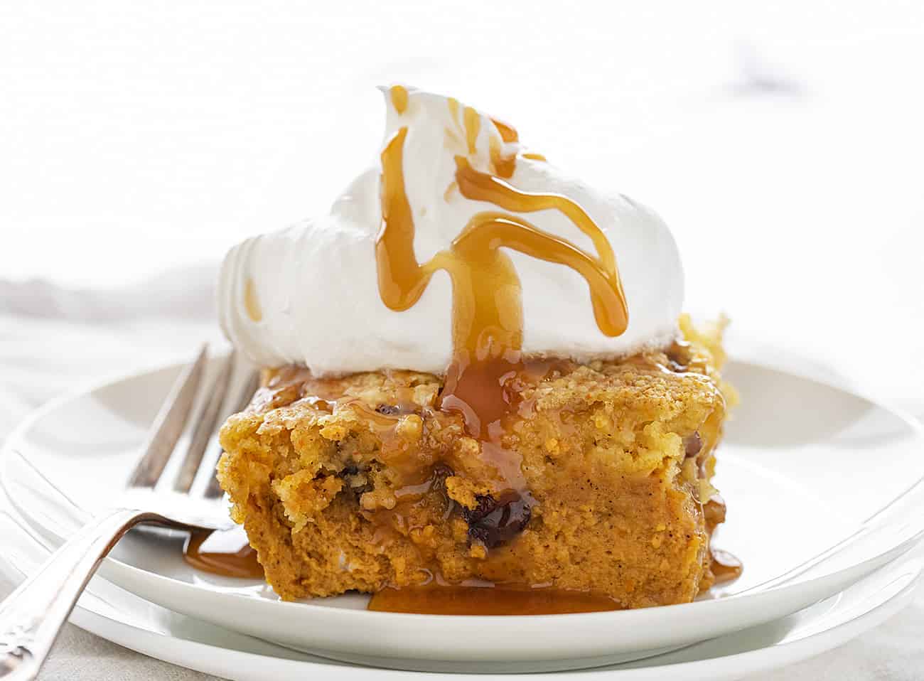 Layered with pumpkin, cake mix, and pecans, this Pumpkin Pecan Dump Cake gets added sweetness from a homemade caramel topping! pumpkinpecandumpcake, dumpcakes, falltreats, desserts, iambaker, baking, homemadecaramelsauce, thanksgivingmenu 一块南瓜山核桃转储蛋糕
