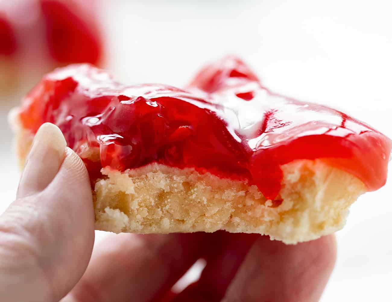 With just four ingredients, these Cherry Bars are as easy as they are delicious. cherry bars, easy desserts, desserts, iambaker, cherry pie filling, butter crumb, homemade icing, potluck recipes, bars 吃樱桃棒