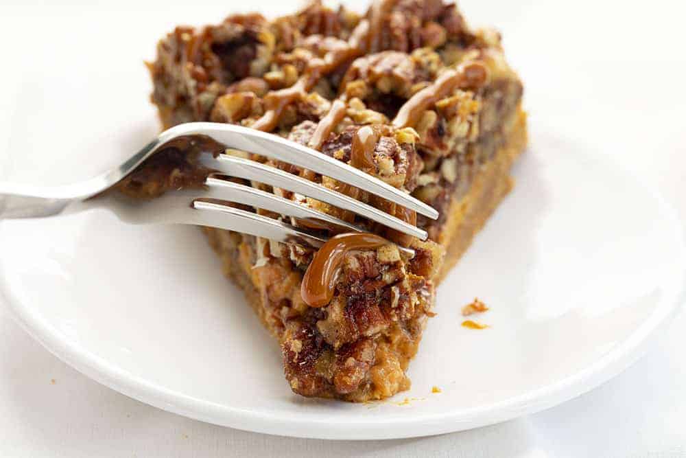 Dulce de Leche Pecan Pie is a dulce de leche cheesecake layered with toasted pecans and a pecan pie filling, all topped and baked with more pecans. Pie, Baking, Pecan Pie, Pecan Pie Cheesecake, Dulce de Leche Pecan Pie, Dulce de Leche Pie, Thanksgiving, Holiday Baking, Christmas, iambaker, i am baker, recipes 叉的牛奶的咬核桃派