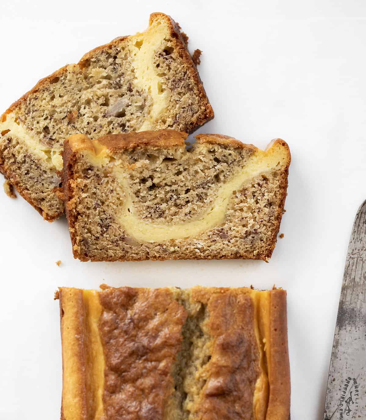 从头顶用刀切成奶油奶酪香蕉面包。烘焙，面包，奶油奶酪，香蕉面包，光香蕉面包，两条面包食谱，甜点，零食，早餐面包，食谱，我是面包师，iambaker